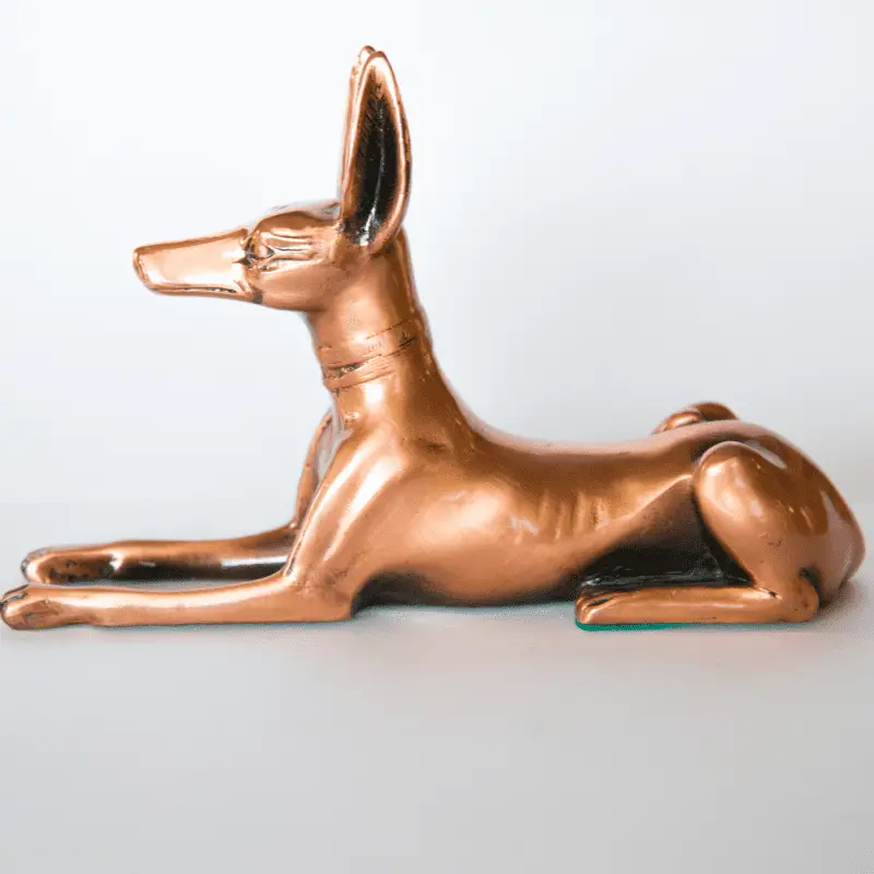 Dog statue of an Egyptian dog, side view on white isolated background.