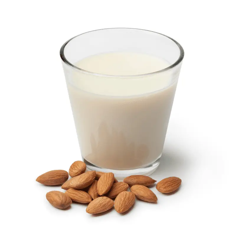 Glass of Almond milk with a heap of almonds on white background