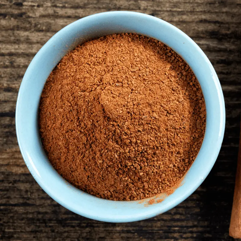 Cinnamon powder in a white bowl