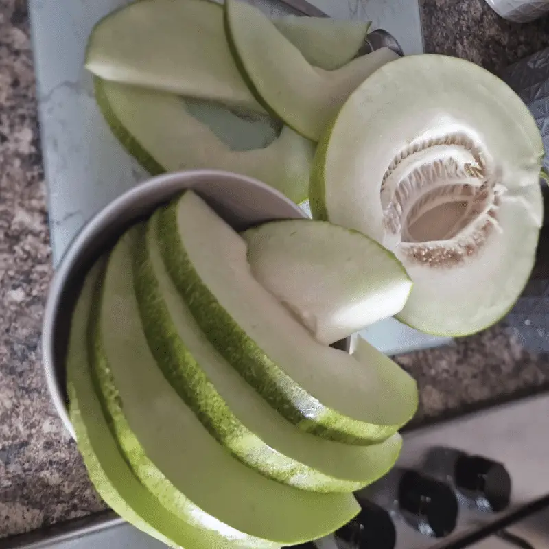 Limelon cut up into slices, showing the seeds and flesh